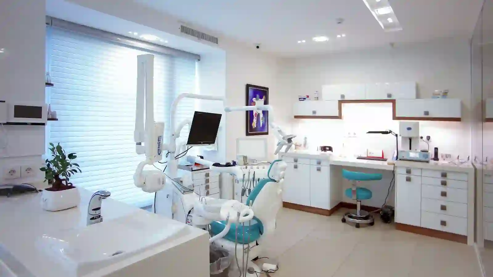 Sunlit dental treatment room with an empty patient chair