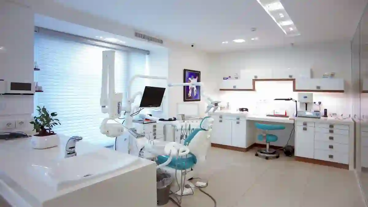 Empty dental chair beside a window in daylight